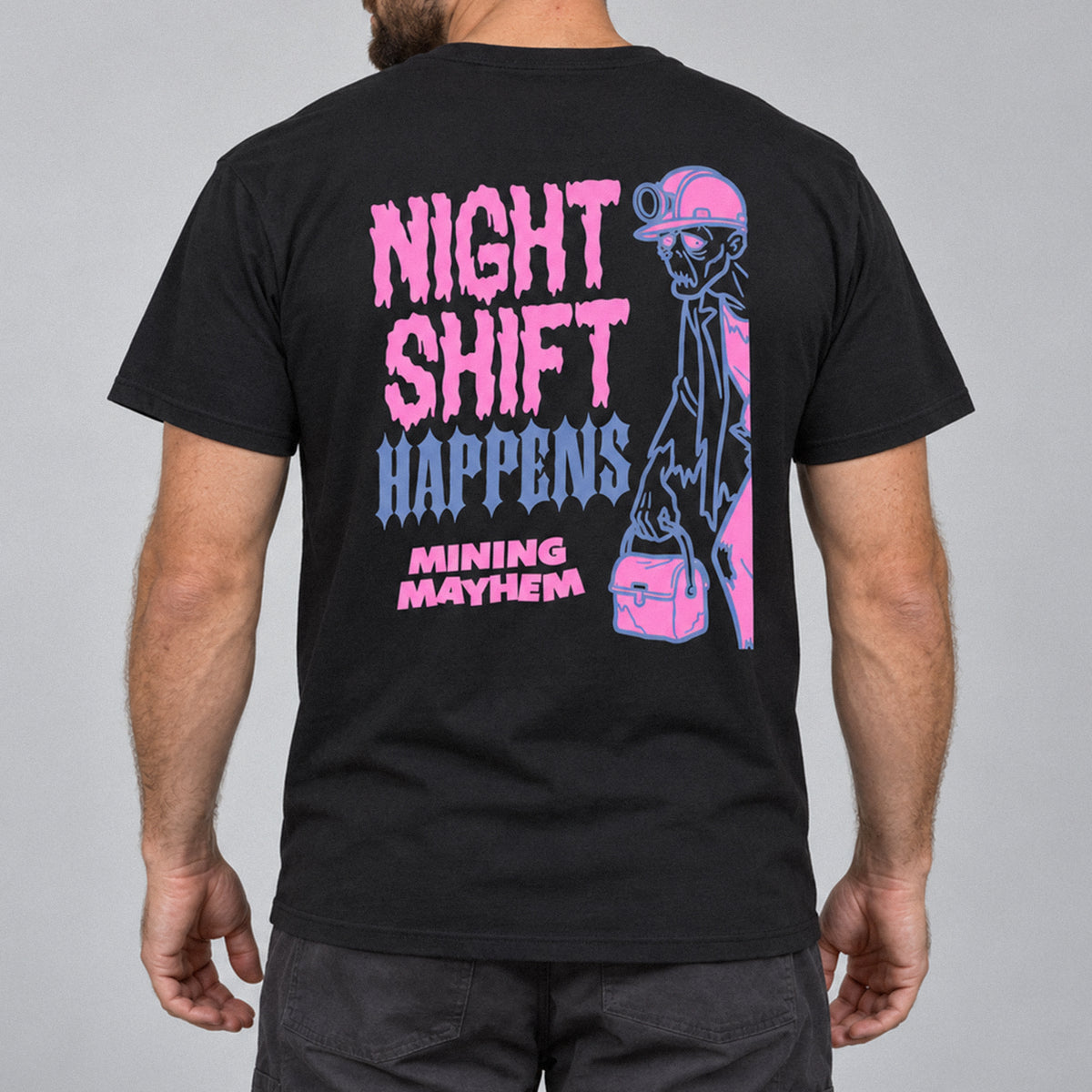 Night Shift Happens t-shirt in black, back print of a zombie miner with crib box, worn