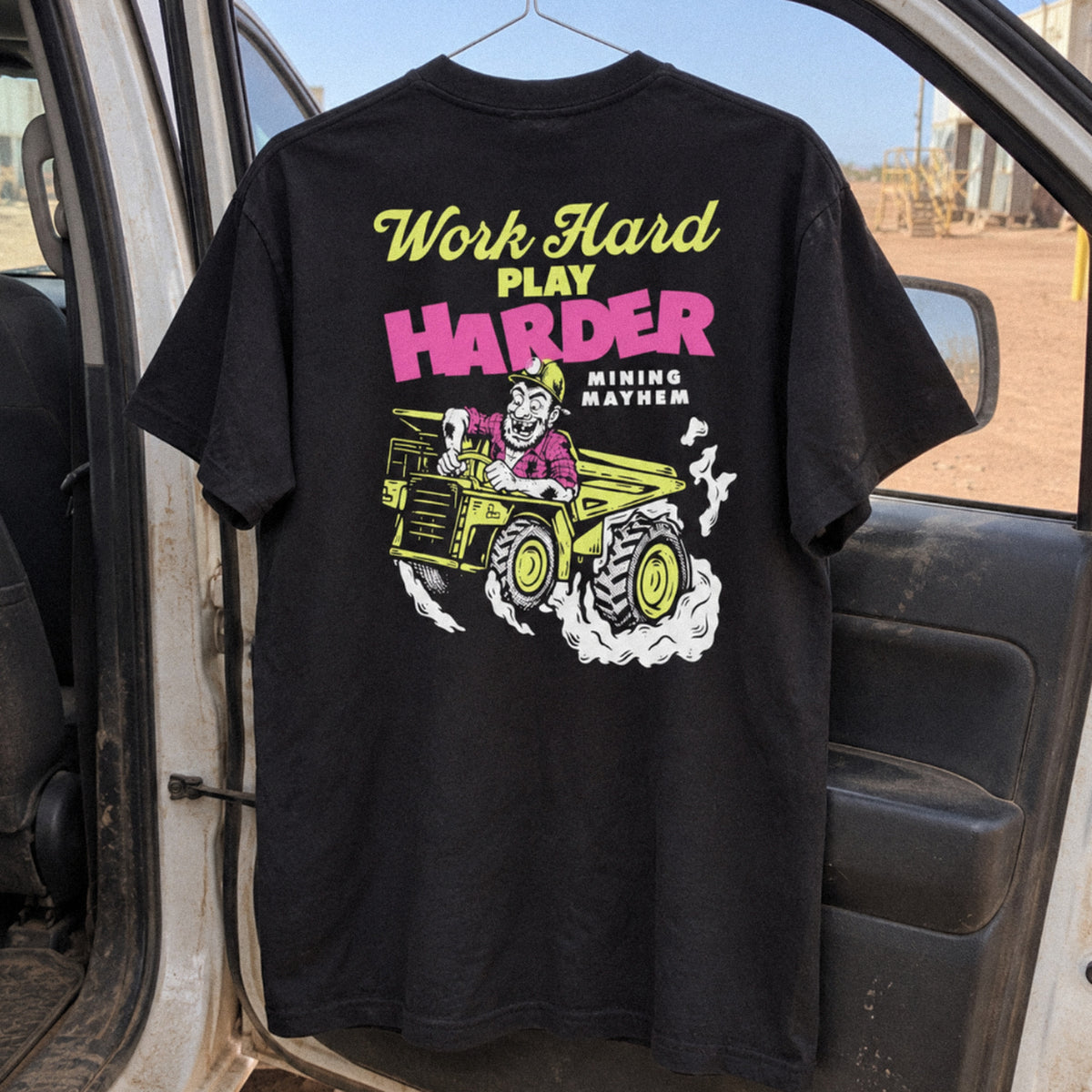 Work Hard Play Harder t-shirt hanging in a ute door on site, back print